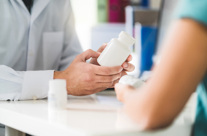 pharmacist explaining medication to patient