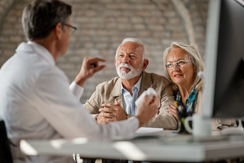 pharmacist helping elderly patient enroll in Medicare plan