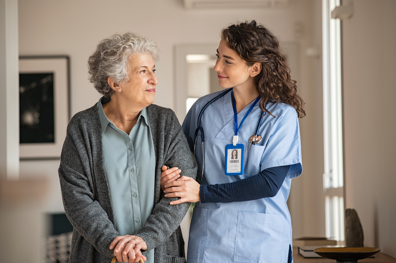 nurse helping elderly patient