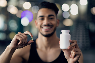 man holding exercise supplement